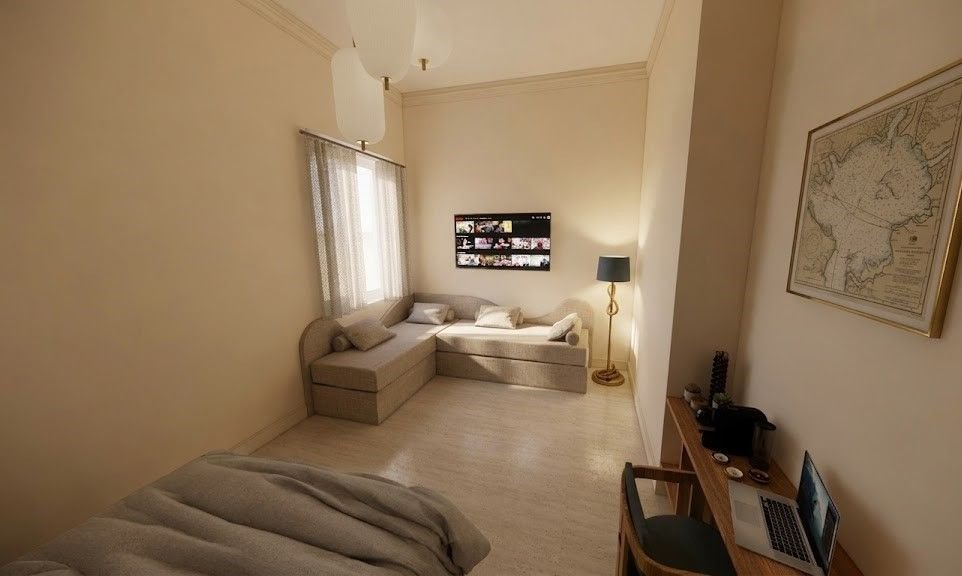 Camera Spaccanapoli: angolo salotto con divano letto, televisore e scrivania
